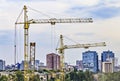 Kharkov, Ukraine - August 2020: Yellow construction building cranes on the construction site of a large residential modern high-