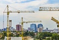 Kharkov, Ukraine - August 2020: Yellow construction building cranes on the construction site of a large residential modern high-