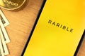 Kharkov, Ukraine - December 20, 2021: Close-up Rarible NFT marketplace open on mobile phone screen. Logo, icon of