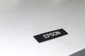 Kharkov, Ukraine - December 24, 2021: Epson logo close-up. Epson printer in workshop