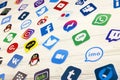 KHARKOV, UKRAINE - DECEMBER 26, 2020: Paper logos of most popular social networks and mobile messengers on wooden background.