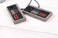 KHARKOV, UKRAINE - DECEMBER 27, 2020: Two old gamepads for 8-bit video game consoles nintendo entertainment system and nes mini on Royalty Free Stock Photo