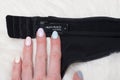 KHARKOV, UKRAINE - MARCH 04, 2019: Label of black lingerie LALAS PEACH in female hand. Close up