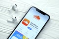 KHARKOV, UKRAINE - MARCH 5, 2021: Soundcloud icon and application from App store on iPhone 12 pro display screen with airpods pro