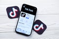 KHARKOV, UKRAINE - MARCH 5, 2021: Tiktok icon and application from App store on iPhone 12 pro display screen on white table