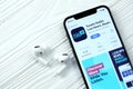 KHARKOV, UKRAINE - MARCH 5, 2021: TuneIn music icon and application from App store on iPhone 12 pro display screen with airpods