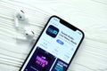 KHARKOV, UKRAINE - MARCH 5, 2021: TuneIn music icon and application from App store on iPhone 12 pro display screen with airpods