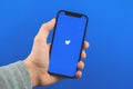 Kharkov, Ukraine - March 9, 2021: twitter logo on mobile phone screen, man holds smartphone with social media Royalty Free Stock Photo