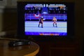 KHARKOV, UKRAINE - NOVEMBER 12, 2020: Sega mega drive video game controller on table with Wrestlemania game on display