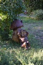 Kharkov, Ukraine, October 6, 2021. A wooden sculpture of dwarf resting under a mushroom