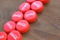 Many red caps with coca cola logo on wooden background Royalty Free Stock Photo