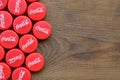 Many red caps with coca cola logo on wooden background Royalty Free Stock Photo