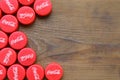 Many red caps with coca cola logo on wooden background Royalty Free Stock Photo