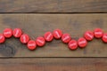 Many red caps with coca cola logo on wooden background Royalty Free Stock Photo