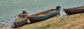 Blue fishing boats are moored on the banks of the Nile river