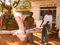 KHARTOUM, SUDAN - 22 NOVEMBER 2008: Two men cut meat.