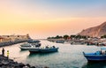 Khasab, Oman - October 5, 2018: Khasab city creek and desert rock scenery with houses at sunset Royalty Free Stock Photo