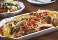 Khashlama in the plate. stewed lamb on the bone with vegetables on wooden desk