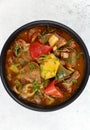 Khashlama stew of beef or lamb meat with vegetables on a white plate, top view. Armenian and Georgian cuisine. Royalty Free Stock Photo