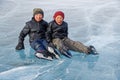 Young boys sittaing after skating on an natural ice rink on Khovsgol lake