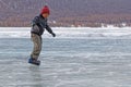 Young boy is skating on an natural ice rink on Khovsgol lake