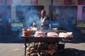 Khayelitsha, South Africa - 29 August 2018 : Woman cooking meat ina township in South Africa