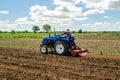 Kherson oblast, Ukraine - May 28, 2020: A farmer is cultivating a field before replanting seedlings. Milling soil