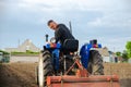 Kherson oblast, Ukraine - May 29, 2021: A farmer on a tractor cleans the field after harvest