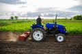 Kherson oblast, Ukraine - May 29, 2021: Farmer on a tractor cleans the field after harvest. Running a small agribusiness