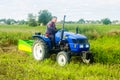 Kherson oblast, Ukraine - September 19, 2020: A farmer on a tractor digging out potato. Farming and farmland. Food production