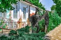 Large metal model of a winged dinosaur on the background of a painted kindergarten building on Kanatna Street in Kherson