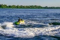 A man has fun on a personal watercraft in the Dnieper River off the coast of Kherson. An adult