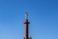 Top of Victory Monument with a statue of Greek goddess Nike Kherson isolated on a blue sky background, close-up