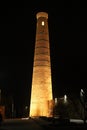 Street market in front of Islam Khoja Madrasa and minaret in the old town at night