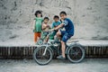 Brothers ans sisters with a bicycle in the historical walled city of the silk road