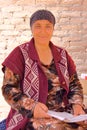 KHIVA, UZBEKISTAN - MAY 2, 2011: Portrait of an Uzbek woman with colorful dress