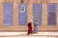 KHIVA, UZBEKISTAN - MAY 3, 2011: Uzbek women walking in the courtyard of Tosh Hovli palace Royalty Free Stock Photo