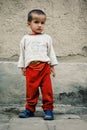 Young boy waiting for his father in the historical walled city of the silk road