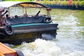 The Khlong Saen Saep boat service, the image shows a rear of public boat when starting the engine and leaving the pier.