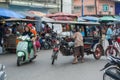 An old man trying to ride his tricycle on the road near local fr Royalty Free Stock Photo