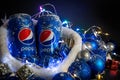 Khmelnytskyi, Ukraine - December 13, 2019: iron bottle of pepsi drink on a black background. The concept of the new 2020, Royalty Free Stock Photo