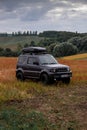 Khmelnytskyi, Ukraine - September 16, 2023: Suzuki Jimny off-road vehicle, dark gray colour, roof rack Niken, autumn day,