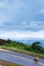 Khmer family driving motorcycle on the mountain asphalt road Royalty Free Stock Photo