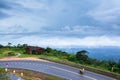Khmer family driving motorcycle on the mountain asphalt road Royalty Free Stock Photo