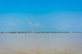 Khmer lake on bright blue sky.