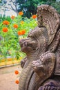 Khmer` s style Naga head made from sand stone at the public temple in Thailand. Naga or large snake according to Hindu belief. Royalty Free Stock Photo