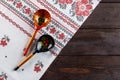 Khokhloma painting. Two wooden spoons with a traditional Russian pattern on a wooden background Royalty Free Stock Photo