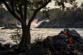 Khone Phapheng Falls at sundown with buddhist monks enjoying the surroundings, Si Phan Don, Champasak Province, Laos