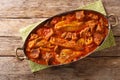 Khoresh bademjan, Persian eggplant, meat and tomato stew braised with spices close-up in a pan. Horizontal top view