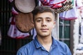 Khorog, Tajikistan August 25 2018: Handsome boy is standing in front of his stall, waiting for buyer of his wares, Khorog,